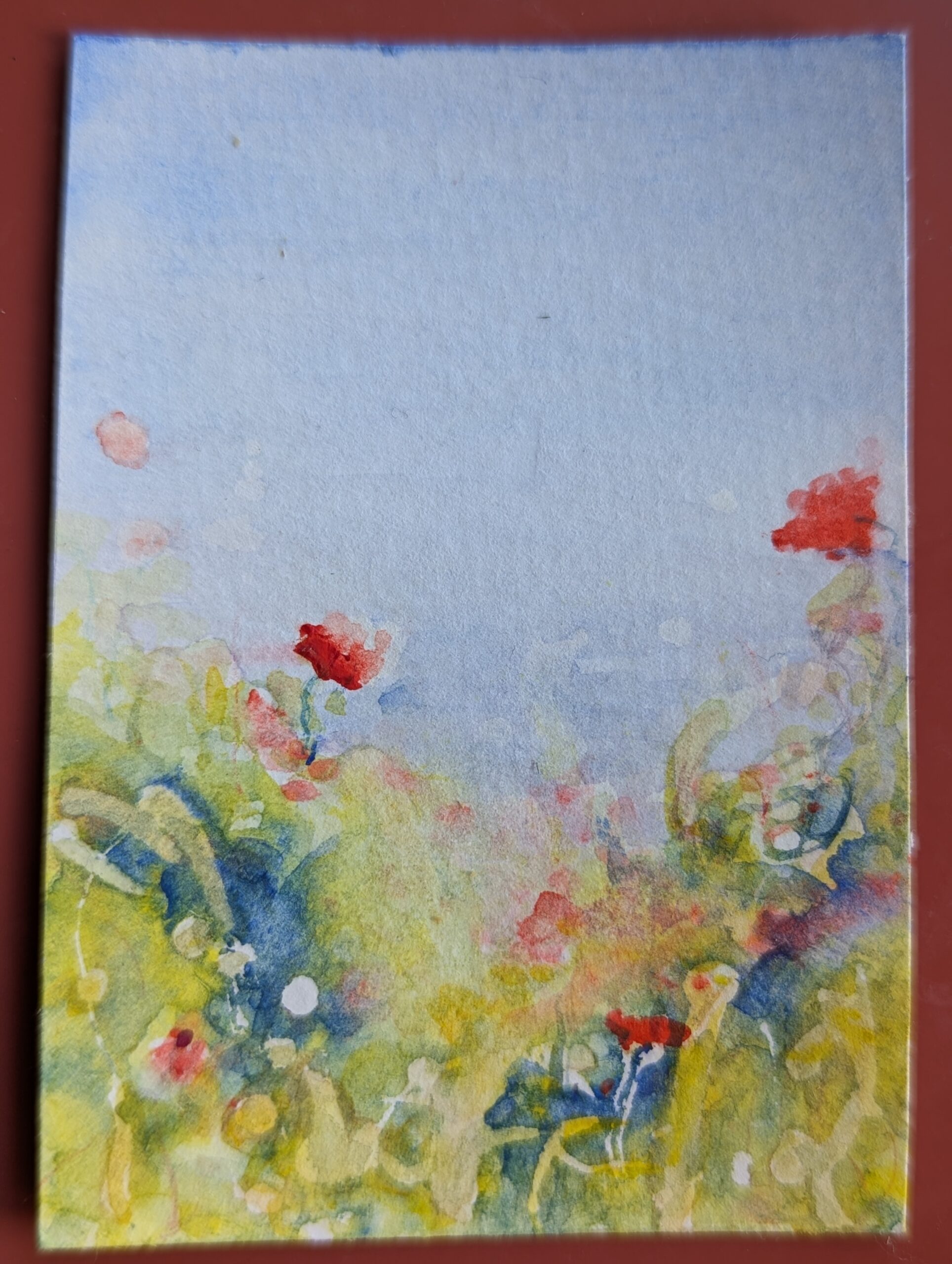 Expressive miniature watercolour painting with poppies. Distant fields