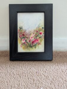 An original floral watercolour by Emma Herbert. Reds, pinks, and greens in a loose impressionistic style lead you through a summer garden